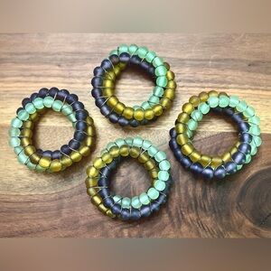 Colorful aqua green, purple & gold glass beaded napkin rings. Silver wire wrap.